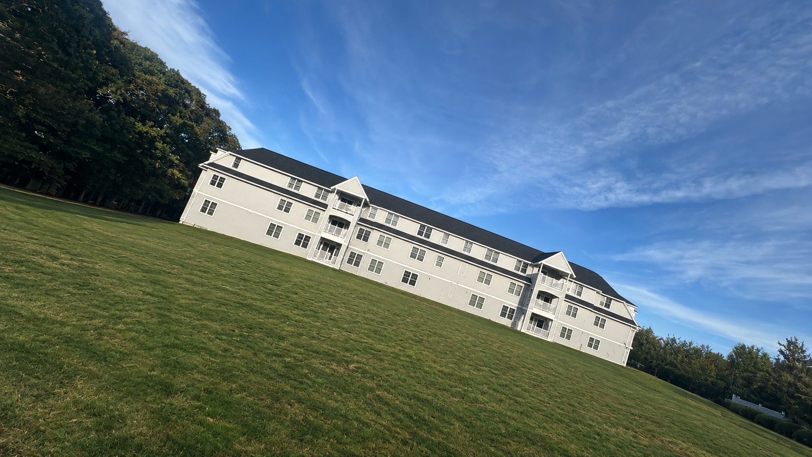Large blue multi-unit residential property completed by Rumali Construction